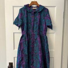 Nwt Elisamama Designer Midi Shirtdress, Purple And Blue/Green, Size M New With Tags. Never Been Worn. No Flaws. Smoke Free Home. Selling For My Mom As She Bought But No Longer Has An Occasion To Wear. Happy To Answer Any Questions! Blue Short Sleeve Shirt Dress For Daywear, Purple Fitted Collared Dress, Fitted Purple Collared Dress, Blue Collared Fitted Midi Dress, Blue Fitted Collared Midi Dress, Purple Collared Summer Dress, Blue Short Sleeve Dress For Daywear, Blue Collared Cotton Midi Dress, Blue Short Sleeve Midi Dress For Daywear