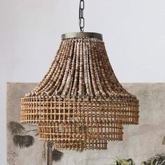 a chandelier made out of wood beads hanging from a ceiling in a room