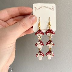 a pair of red and white polka dot dangle earrings