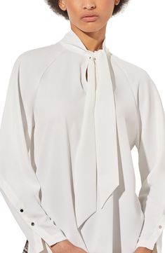 Raglan long sleeves underscore the contemporary style of a tie-neck top that's ideal for the office and beyond. 26" length (size XS) Split neck with ties Long sleeves with button cuffs 100% polyester Machine wash, dry flat Imported White Tie Sleeves Blouse For Office, Elegant Tie Neck Top For Office Wear, White Tie Neck Blouse For Office, White Tie Neck Top With Tie Sleeves, White Tie Neck Blouse For Formal Occasions, Office Tops With Tie Sleeves And Long Sleeve, Modern Long Sleeve Blouse For Business, White Long Sleeve Blouse With Tie Sleeves, Long Sleeve Tops With Tie Sleeves For Office