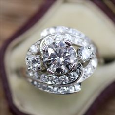 a diamond ring sitting on top of a cushion