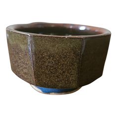 a brown and blue bowl sitting on top of a table