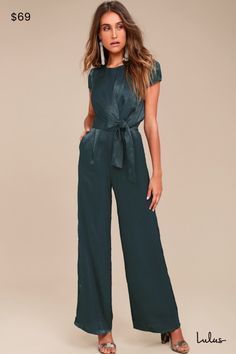 Be the perfect hostess in the Lulus Let Me Entertain You Dark Green Satin Wide-Leg Jumpsuit! Silky satin shapes a rounded neckline, cap sleeves, and a tying waist sash that creates a chic, knotted accent. Wide-leg pants with diagonal front pockets. Hidden back zipper/clasp. Fit: This garment fits true to size. Length: Floor length. Size medium measures 61" from shoulder to hem. Inseam: 31.25 Front Rise: 13.00 Bust: Great for any cup size. Waist: Fitted - very fitted at natural waist. Hip: Not Fi Winter Wedding Guest Pants Outfit, Spring Satin Jumpsuits And Rompers In Solid Color, Elegant Satin Jumpsuit Or Romper In Solid Color, Chic Satin Jumpsuits And Rompers In Solid Color, Chic Solid Color Satin Jumpsuits And Rompers, Fitted Satin Jumpsuits And Rompers For Work, Fitted Satin Jumpsuits And Rompers For Spring, Spring Satin Fitted Jumpsuits And Rompers, Formal Short Sleeve Jumpsuits And Rompers