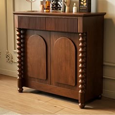 a wooden cabinet sitting in the corner of a room