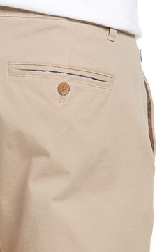 Made from soft four-way-stretch fabric, these slim-tailored chinos feature a curved waistband and a zip pocket for secure storage while you're on the move. 14" leg opening; 10 1/2" front rise; 15 1/2" back rise (size 32x30) Zip fly with button closure Side slant pockets; side zip pocket; back button-welt pockets Moisture-wicking, wrinkle-resistant fabric engineered for dryness and comfort 92% cotton, 8% spandex Machine wash, tumble dry Imported Men's Clothing Beige Chinos For Business Casual With Pockets, Beige Business Casual Chinos With Pockets, Chinos With Pockets And 5-inch Inseam, Business Casual Chinos With Hip Pockets, Curved Waistband, Welt Pockets, Welt Pocket, Side Zip, Men's Clothing