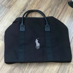 Authentic Ralph Lauren Sport Bag. Perfect Bag For Day Trip Or Even To The Gym! Size 14.5x18.5 All Black With Gray Logo And Also Have A Side Pocket. Very Spacious. Can Be Worn Over The Shoulder And Carry From Handle Black Travel Bag With Detachable Handle For On-the-go, Black Pouch Bag With Leather Handles, Elegant Black Canvas Bag For Everyday, Black Canvas Satchel For Shopping, Black Top Handle Travel Bag With Detachable Handle, Elegant Black Canvas Bag With Double Handle, Elegant Black Canvas Bag For Travel, Elegant Black Canvas Travel Bag, Black Satchel Weekender Bag With Detachable Handle