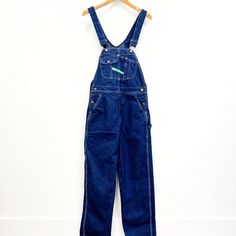 Vintage Key bib overalls, these are traditionally cut bib overalls and  feature; adjustable straps lots of pockets on the bib  a green fabric label on the bib that reads "Key "Imperial" Aristocrat of Overalls' buttons at the waist pockets at the hip and on the seat hammer loop, ruler pocket  zip fly lots of white top stitching Of a heavyweight, 100% cotton denim in a dark blue wash. Tagged a mens size 34 (waist) X 32 (length), measurements when laid out flat are; 17 1/2 inches at the waist 21 1/2 inches at the hip 13 1/2 inch rise 31 inch inseam the straps are adjustable which makes the top portion basically one size fits most In good, preworn, vintage condition with no holes, stains, or funky odors....it has a couple of loose threads in the top stitching but nothing major. We are happy to Utility Style Dark Wash Denim Jumpsuit With Bib Front, Dark Wash Utility Denim Jumpsuit With Bib Front, Denim Bib Front Overalls With Pockets, Utility Cotton Overalls With Belt Loops, Utility Denim Overalls With Belt Loops, Utility Bib Front Overalls With Suspenders, Denim Blue Bib Front Shortalls With Pockets, Denim Blue Bib Front Overalls, Medium Wash Shortalls With Bib Front And Pockets