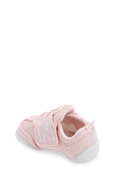 Baby's first steps will be supported in this sporty sneaker featuring a roomy toe box and easy-on/off strap. Adjustable hook-and-loop strap Removable insole Textile and leather upper/synthetic lining/rubber sole Imported Sporty Breathable Sneakers For Playtime, Sporty Breathable Sneakers For Casual Wear, Pink Non-slip Low-top Walking Shoes, Low-top Running Sneakers With Soft Sole, Sports Sneakers With Soft Synthetic Sole, New Balance Training Sneakers With Rubber Sole, Synthetic Sneakers With Soft Sole, Soft Sole Synthetic Sneakers, Synthetic Sneakers With Soft Sole, Closed Toe