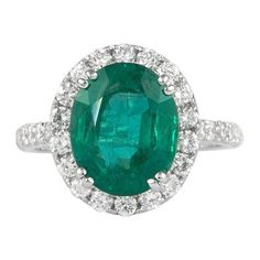 Lovely emerald with diamond halo ring. By Alexander Beverly Hills. 4.05 carat oval emerald apx F2 complimented with 32 round brilliant diamonds, 1.01ct. Approximately H/I color and SI clarity. 5.06ct total gemstone weight, in 18k white gold. Accommodated with an up-to-date appraisal by a GIA G.G. once purchased, upon request. Please contact us with any questions. Item Number R8433 Modern Diamond Jewelry, Sapphire Cocktail Ring, Emerald Diamond Ring, Diamond Halo Ring, Diamond Cocktail Rings, White Gold Diamond Rings, Shiny Things, Halo Diamond Ring, Halo Ring