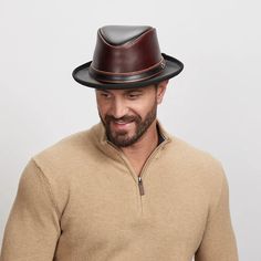 A smiling man wearing a wine colored fedora Black Leather Hat Bands For Fall, Black Leather Hat For Fall, Fitted Black Leather Top Hat, Formal Brown Top Hat For Fall, Brown Leather Brimmed Fedora, Black Leather Fedora For Fall, Fitted Leather Hat Band For Fall, Leather Hats With Short Brim For Fall, Brown Leather Fedora For Fall