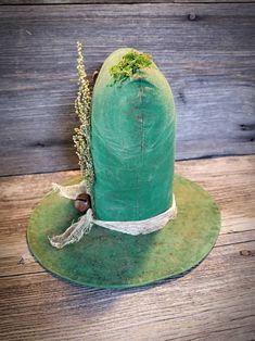 a green hat is sitting on a wooden table