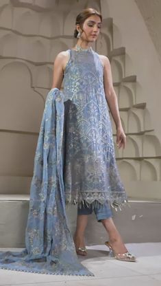 Elegant Blue Short Shirt with Capri Pakistani Party Wear Curated in a wonderful blue tone, blue bell embraces a perfection in its subtle embroidery and sequins work. Paired with a floral design dupatta and a tonal trouser this ensemble is a step towards slaying this season. A stellar piece curated on a navy blue lawn base painstakingly worked in shades of gray & ash white thread is topped with silver spangles & zari creating a floral pattern for the front. Detailed Description: SKU: PB0033 Detai Blue Sequined Party Wear Sets, Elegant Blue Sequined Sets, Elegant Blue Sets With Sequins, Blue Lawn Suit With Dabka Work For Reception, Blue Embroidered Party Wear Dupatta, Blue Embroidered Party Wear Sets, Blue Anarkali Dupatta With Sequins, Summer Blue Lawn Suit With Chikankari Embroidery, Blue Summer Lawn Suit With Chikankari Embroidery