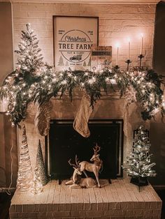 a fireplace decorated for christmas with deer and stockings