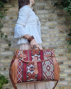 "🌟 Get ready to explore the world with our Customized Large Leather Weekender Bag for Women; a large duffle bag in boho style, handcrafted from upcycled vintage Moroccan carpet!🌟  This vintage style large leather weekender bag for women makes a unique gift for avid travellers and wanderlust girls. Combining traditional Moroccan crafts with modern elegance and practicality, this custom leather travel bag is like no other. It has been handcrafted from true vintage kilim carpets that have been up Brown Rectangular Duffle Bag With Detachable Handle, Brown Travel Bag With Top Carry Handle, Brown Travel Bag With Top Carry Handle For Trips, Brown Weekender Bag With Detachable Handle For Travel, Tote Duffle Bag With Top Carry Handle For Trips, Satchel For Overnight Trips With Top Carry Handle, Brown Weekender Bag With Detachable Handle, Travel Duffle Bag With Tote Shape, Leather Satchel For Overnight Trips With Top Carry Handle