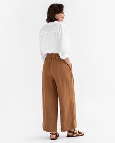 Elevate your style with the ALCUDIA Wide Leg Linen Pants in Cinnamon. These high-rise pants feature a wide leg design and are designed to hit below the ankle with an inseam of 28.5"/72 cm. The pants offer both fashion and functionality with two side seam pockets, providing convenient storage while maintaining a sleek silhouette. The elastic waist ensures a comfortable and flattering fit, making these pants perfect for any occasion.• Wide leg design• 2 side seam pockets for added functionality an Effortless Wide-leg Bottoms With Pockets, Effortless High-waisted Loose-fit Pants, Effortless Wide-leg Relaxed Fit Pants, Effortless Wide-leg Pants With Relaxed Fit, Effortless Relaxed Fit Wide-leg Pants, Linen Bottoms With Elastic Waistband For Fall, Fall Linen Bottoms With Elastic Waistband, Flax Wide Leg Relaxed Fit Pants, Relaxed Fit Linen Bottoms For Fall