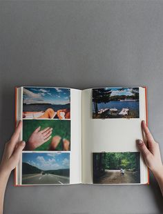 someone holding an open book in their hand with pictures on the pages and photos inside