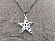 "Love this fun and whimsical silver star necklace! Made from allergy free, plated silver. It hangs from a silver plated simple 18\" chain necklace with a lobster clasp. The star measure 1\" long by 3/4\" across. I have matching earrings in my shop, if you would like the whole set. https://www.etsy.com/listing/210027881/silver-star-earrings-celestial-earrings?ref=shop_home_active_21 This is perfect for everyday, year round wear and would also make a wonderful gift. Thanks for stopping by and plea Silver Star Print Necklace, Silver Star Print Necklace For Gift, Silver Star Print Necklace Perfect For Gift, Silver Necklace With Star Print For Gift, Silver Star Print Jewelry As Gift, Silver Star Print Jewelry For Gift, Silver Jewelry With Star Print For Gift, Silver Jewelry With Star Print As Gift, Silver Star Charm Necklace