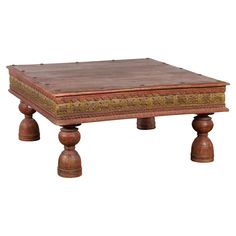 an old wooden table with two bells on each side and a brown leather cover over the top