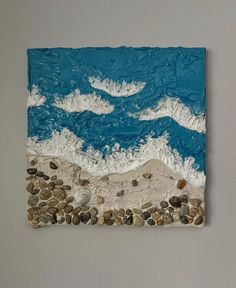 a piece of art with rocks and water on the bottom is made to look like waves