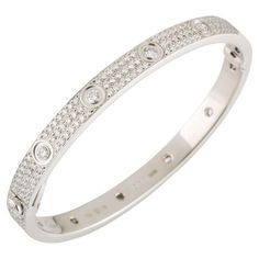 CARTIER LOVE BRACELET Cartier 'Love' bangle bracelet crafted in 18 karat white gold with diamond screw tops and pave set round brilliant cut diamonds (D-F in color, VVS clarity) Signed Cartier, 17, 750, with serial number and hallmarks The bracelet is presented with a Cartier box and certificate upon sale In 18k white gold and pavé of diamonds total 3.70ct In size 17 Original at shop at 67.500€ If the robust locking mechanism and miniature screw heads that characterized Cartier’s Love bracelet w Love Bracelet Cartier, Cartier Diamond Bracelet, Cartier White Gold, Cartier Love Bangle, Bracelet Cartier, European Jewelry, David Webb, Bracelet Love, French Jewelry