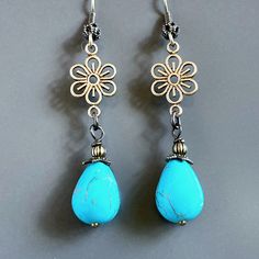 "Turquoise Teardrop Earrings - Turquoise Magnesite Teardrop Beads dangle from antiqued Brass Flower Cutouts.  The Turquoise Beads are topped with Antiqued Brass Beadcaps and Beads. Antiqued Brass  Earwires Earrings measure 2.25\" from top of earwires to bottom of beads." Vintage Turquoise Flower Earrings, Turquoise Teardrop Flower Earrings For Gift, Vintage Turquoise Dangle Flower Earrings, Turquoise Flower Charm Earrings For Gift, Turquoise Flower Earrings As A Gift, Elegant Turquoise Flower Earrings Nickel Free, Gift Turquoise Flower Charm Earrings, Elegant Turquoise Nickel-free Flower Earrings, Gift Turquoise Flower Earrings