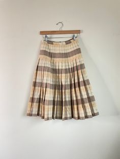 This skirt was my grandmothers and was later worn by my mother. Features a side zip. Label: In'n Outer by Sportrite Material not listed, feels like wool or a wool blend Size: fits 24in waist, refer to measurements Excellent Vintage Condition, one small mark see last photo.  MEASUREMENTS IN INCHES (laid flat + unstretched double where needed) : Waist: 12 Hip: 20 Length: 27 Each vintage piece has been preloved. Minor fading + wear is expected & often adds to the character. All items are cleaned & from a smoke & pet free building. We hope you appreciate this find as much as we do. Fitted Vintage Mini Skirt, Vintage Accordion Pleats Skirt For Spring, Vintage Accordion Pleats Skirt For Fall, Vintage Lined Skirt For Fall, Spring Vintage Skirt With Accordion Pleats, Vintage Skirt For Fall, Spring Vintage Accordion Pleats Skirt, Vintage Beige Cotton Skirt, Beige Vintage Cotton Skirt