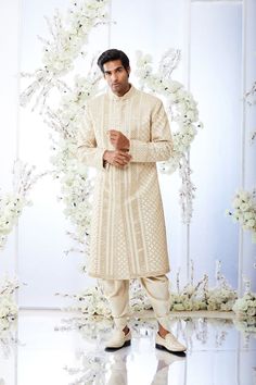 This two-tone beige sherwani set features all over gota patti embroidery on a raw silk base. The ensemble is paired with a grey silk kurta and a gold twill patiala salwar. Complimenting stole and footwear is also available.From Seema Gujral's Tuscan Summer collection. DELIVERY TIMEPlease allow 8-12 weeks for your outfit to arrive.FABRIC DETAILSRaw SilkProfessional cleaning only. Seema Gujral, Embroidered Sherwani, Salwar Pants, Sherwani Groom, Embroidery Fashion Detail, Sherwani For Men, Patiala Salwar, Silk Kurta, Gray Silk