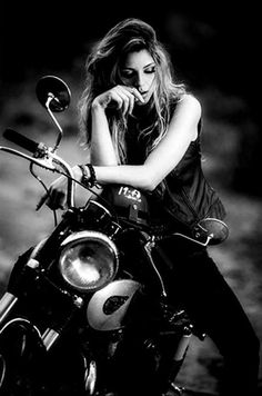 black and white photograph of a woman sitting on a motorcycle