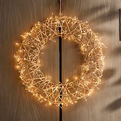 a lighted wreath hanging on the side of a door