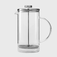 a glass french press coffee maker on a white background