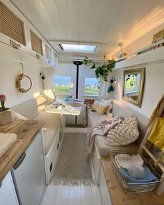 the interior of a small rv with white walls and wood flooring is shown in this image