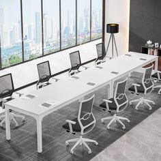 an empty conference room with white tables and chairs in front of large windows overlooking the city