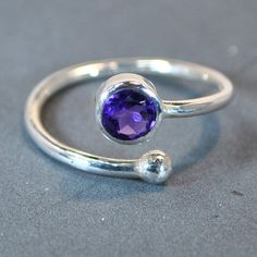 Fine adjustable sterling silver ring with amethyst setting.  Available in 2 sizes, U.K sizes: K & N. U.S. sizes: 5 ½ & 7. DO NOT FORGET TO SEND YOUR FINGER SIZE WITH ORDER. UK sizes can be adjusted by either closing or opening 2 sizes smaller or bigger.  US sizes can be adjusted by either closing or opening one size smaller or bigger. Technical details: stone size: 5mm/0.2 inches round. Thickness of shank: 1,6mm/0.06 inches. Other stones available: blue topaz, blue moonstone, garnet, peridot, tu Amethyst Set, Amethyst Gem, Blue Moonstone, Multi Stone Ring, Moonstone Ring, Adjustable Ring, Adjustable Rings, Cross Pendant, Stone Rings