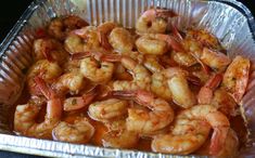 a pan filled with shrimp sitting on top of a table