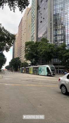 a car is parked on the street in front of tall buildings