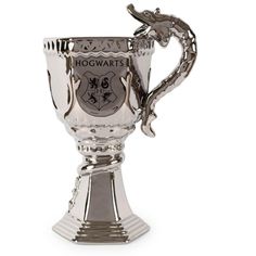 a silver trophy cup with a dragon on the side and hogwart's crest