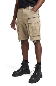 These stretch-cotton shorts feature large zip cargo pockets that add rugged and functional style you'll love for a day in the workshop or wilderness. 10" inseam; 22" leg opening; 12 3/4" front rise; 16 1/2" back rise (size 32) Zip fly with button closure Front slant pockets; side cargo pockets, back flap pockets 97% cotton, 3% elastane Machine wash, tumble dry Imported Outdoor Khaki Cargo Shorts With Hip Pockets, Khaki Cargo Shorts With Hip Pockets For Outdoor, Utility Style Bottoms With Cargo Pockets, Short Cargo Pants With Pockets For Hiking, Utility Style Cargo Shorts, Short Cargo Pants With Side Pockets For Hiking, Utility Cargo Bermuda Bottoms, Utility Cargo Style Bermuda Bottoms, Short Length Utility Cargo Pants With Cargo Pockets