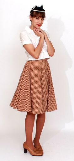 S T R A I G H T T A L K ▲ Circa: 1950s ▲ Tag: Carole Chris of California ▲ Material: Cotton ▲ Condition: Very Good D E T A I L S ▲ Checkered brown circle skirt in a sturdy quilted cotton ▲ Brown, beige and orange checkerboard/diamond pattern ▲ Button and covered zipper to side of waist ▲ Defined waistline with full circle skirt C O N D I T I O N ▲ Very Good S I Z I N G ▲ Would probably best fit a size XS best Waist: 23-24 inch Hips: free Waist to hem (skirt length): 24 inch FOLLOW US ON INSTAGRA Retro Brown Skirt, Retro Brown Mini Skirt, Vintage Cotton Brown Skirt, Vintage Fitted Pleated Skirt, Retro Pleated Mini Skirt, Fitted Vintage Mini Skirt, Vintage Fitted Cotton Skirt, Fitted Vintage Skirt For Vintage Fashion, Retro Fitted Full Skirt