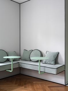 a corner couch with two tables in front of it