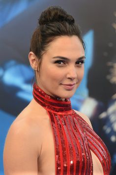 a woman in a red dress posing for the camera