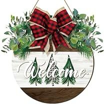 a welcome sign hanging from the side of a wooden plaque with red and white bows