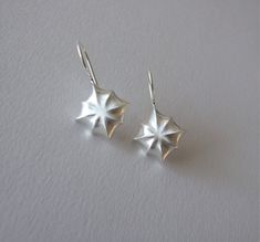 These beautiful earrings are inspired by the sparkling stars in the night sky. They are impressive and are great to wear as wedding jewelry or for other special occasions. They are made of 14k gold, and you can choose which color gold you want them to be made of- yellow or white gold. I plate the white gold with rhodium, as is common in white gold jewelry. I add 2 silicone stoppers for the earrings, that you can slip on the post after you wear the earrings so they won't fall off the ears. Each earring is 1.17 inches ( 3 cm ) long including the ear hoops, and the diameter of the star is 0.66 inches ( 1.7 cm ). Please note that the picture of the earrings on the model includes gemstones, but the item you are paying for does not include the gemstones! If you want to buy the earrings with the Elegant Starburst Earrings For Party, Elegant Silver Earrings With Star Charm, Elegant Starburst Earrings For Anniversary, Star-shaped Earrings With Lever Back For Gifts, Sterling Silver Star Earrings For Wedding, Starburst Earrings For Pierced Ears As Gift, Wedding Star-shaped Sterling Silver Earrings, Elegant White Gold Earrings With Star Charm, Elegant Star Charm Earrings For Anniversary