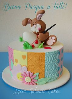 there is a cake decorated with an animal on the top and flowers in the bottom