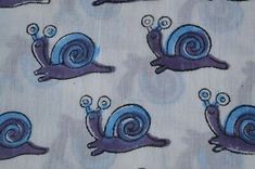 a blue and purple snail fabric with small snails on it's back, in various positions