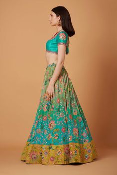 Editor's Note Aqua Turquoise Ombre Hand Embroidered Lehenga Set With SB Signature Wild Flower Print, Sunkissed Yellow Suede Velvet Embroidered Border and Silk Organza Embroidered Scallop Dupatta. Fabric: Dupion, Pure Crepe, Silk Organza, Suede Velvet Color: Aqua Turquoise Care: Dry Clean Only Disclaimer: Product Color May Slightly Vary Due To Photographic Lighting Sources Or Your Monitor Setting. About the Designer Siddhartha Bansal, label epitomise its design philosophy touring around " Golden Anarkali Style Turquoise Lehenga With Pallu, Designer Green Lehenga With Floral Embroidery, Turquoise Anarkali Lehenga With Pallu, Designer Turquoise Lehenga With Dupatta, Bollywood Style Green Lehenga With Floral Embroidery, Green Bollywood Lehenga With Floral Embroidery, Turquoise Anarkali Lehenga With Zari Work, Designer Wear Turquoise Lehenga For Navratri, Turquoise Designer Lehenga For Navratri