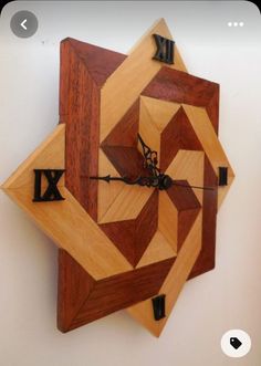 a wooden clock that is on the wall