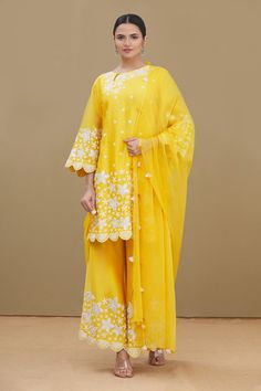 Mustard yellow kurta with all-over floral applique work, round neckline and scallop edged hem. Comes with palazzo and dupatta.
Component: 3
Embroidered
Neckline: Round
Sleeve Length: Full
Fabric: Kurta and Palazzo:  Chanderi; Dupatta: Chiffon
Color: Yellow
Dori and applique work
Keyhole at the neckline with button closure
Scallop edged sleeves, hem and palazzo
Embroidered palazzo
Tassels at the hem of dupatta - Aza Fashions Kurta And Palazzo, Yellow Kurta, Chanderi Dupatta, Yellow Embroidery, Kurta Set For Women, Applique Work, Embroidered Neckline, Fashion App, Kurta Set