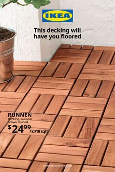 a wooden floor with a plant on it and a price label for the wood decking will have you flored