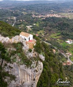 an aerial view of a small house on top of a cliff