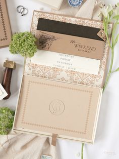 the wedding stationery is laid out on top of each other, including an envelope